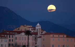 A 'Super Snow Moon' rise over Ajaccio on the French Mediterranean island of Corsica, on February 19, 2019.