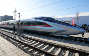 A prototype of the CR450 bullet train that will run at 400 kilometers per hour debuted in Beijing on Dec. 29, said the country's railway operator China State Railway Group Co., Ltd.
  The train is capable of running at 450 kilometers per hour in test. (Xinhua/Ju Huanzong) (Photo by Ju Huanzong / XINHUA / Xinhua via AFP)