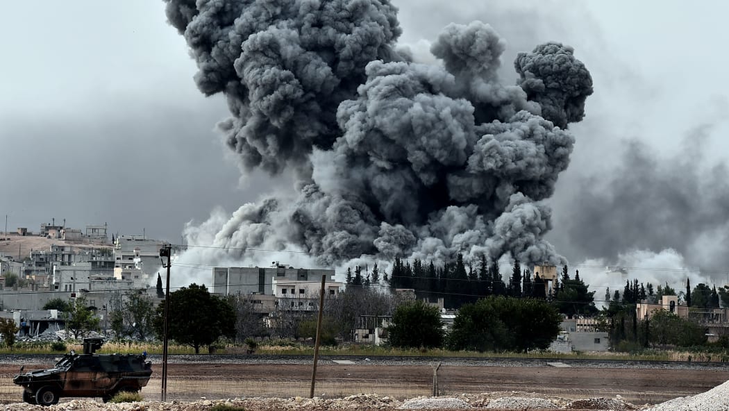 Smoke rises after a strike on Kobane by the Kurds, as seen from the Turkish-Syrian border.