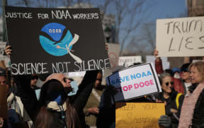SILVER SPRING, MD - MARCH 03: Hundreds of demonstrators gather to protest against Department of Government Efficiency (DOGE) cuts outside the headquarters of the National Oceanic and Atmospheric Administration on March 03, 2025 in Silver Spring, Maryland. Last week the Trump administration fired about 800 probationary staff at NOAA, one of the world’s premier centers for climate science. The layoffs are on top of about 500 employees who left the agency after taking the so-called deferred resignation offer.   Chip Somodevilla/Getty Images/AFP (Photo by CHIP SOMODEVILLA / GETTY IMAGES NORTH AMERICA / Getty Images via AFP)