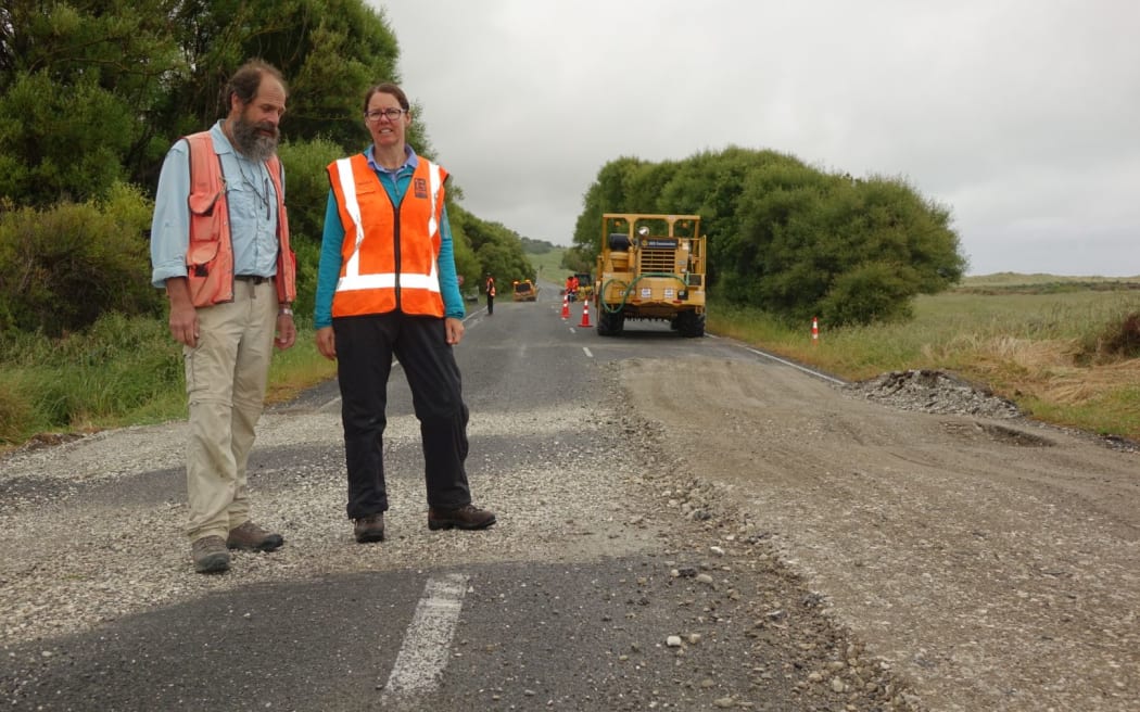 GNS scientists Russ Van Dissen and Nicola Litchfield show how State Highway 1 at Ward has been shunted sideways in the quake - the centre line is misaligned.