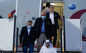 US citizens Siamak Namazim right, (at back), Emad Sharqi, left, and Morad Tahbaz, centre, disembark from a Qatari jet upon their arrival at the Doha International Airport in Doha on18  September, 2023.