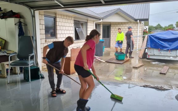 Family help with the clean up of Raewyn Flexman's home in Te Kuiti.