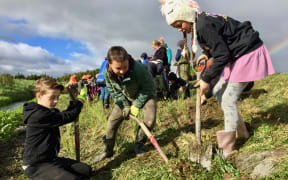 Students from Featherston's St Teresa's School working on a creek restoration project, funded by Greater Wellington Regional Council. GWRC recently approved consent for a quarry further upstream.