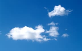 An image of a blue sky with some clouds.