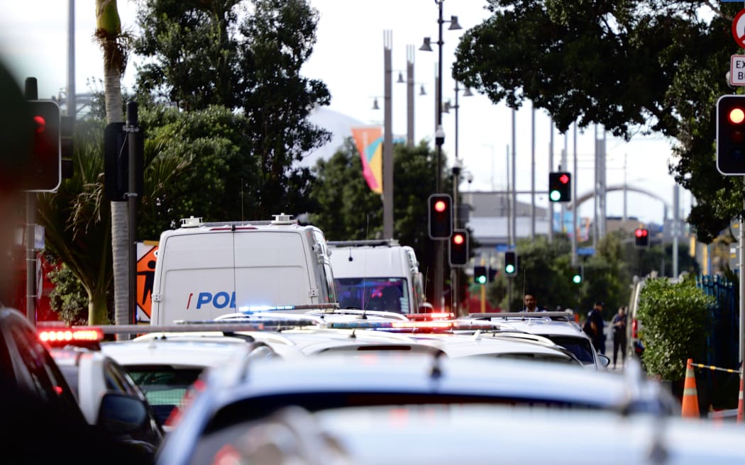 Emergency service vehicles can be seen at the scene of a serious shooting incident in downtown Auckland on 20 July, 2023.