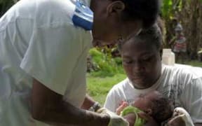 Registered nurse, Miriam Nampil, 55 years, vaccinates the first baby with a commercial drone delivered vaccine. Baby Joy Nowai, one month old, receives vaccines BCG to prevent tuberculosis and Hepatitis B.