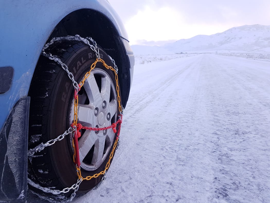 Snow in Tekapo, chains needed on road.
