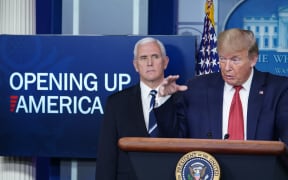 US President Donald Trump flanked by US Vice President Mike Pence, speaks during the daily briefing on the novel coronavirus, which causes COVID-19, in the Brady Briefing Room of the White House on April 16, 2020, in Washington, DC. (Photo by MANDEL NGAN / AFP)