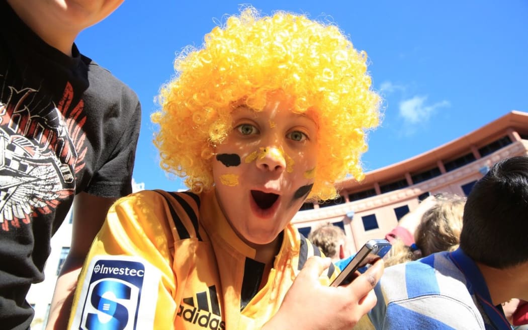 A young fan awaits the Hurricanes arrival in Civic Square.