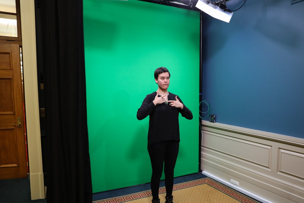 NZ Sign Language interpreter Melissa Sutton (Ngāti Maniapoto) in the Parliament TV sign studio