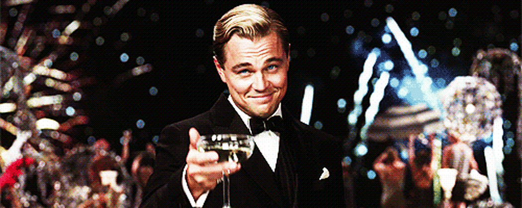 Jay Gatsby raising a glass of champagne, to toast.