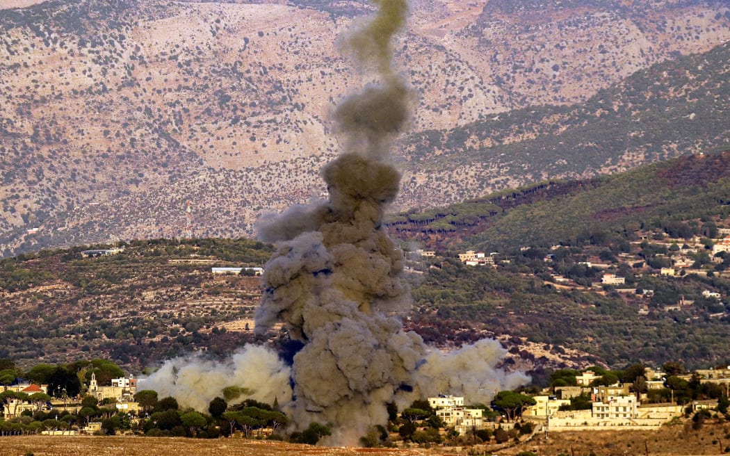 A smoke plume erupts after an Israeli airstrike targeted the outskirts of the village of Ibl al-Saqi in southern Lebanon on September 30, 2024. (Photo by Rabih DAHER / AFP)