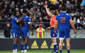 French player Benjamin Fall is shown a red card by Australian referee Angus Gardner.