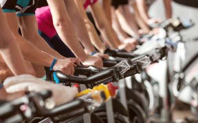 gym detail shot - people cycling; spinning class