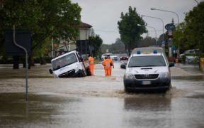 Rescuers stand by a truck following floods in Castel Bolognese, near Ravenna after continuous rain caused flooding in northern Italy, 2023.