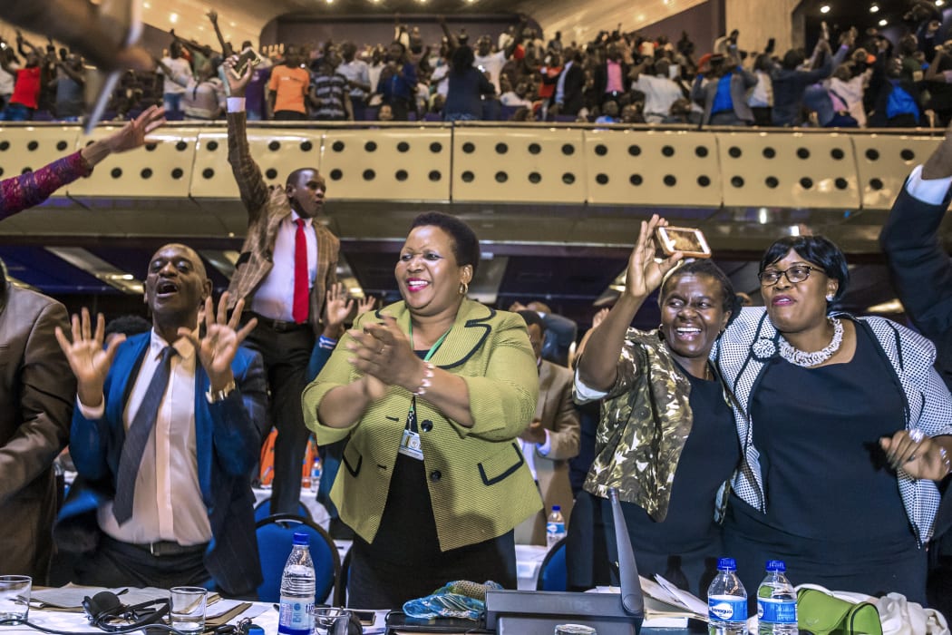 Zimbabwe's members of parliament celebrate after Mugabe's resignation.