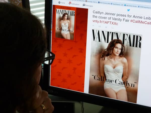 In this June 1, 2015 photo, a journalist looks at Vanity Fair's Twitter site with the Tweet about Caitlyn Jenner, who will be featured on the July cover of the magazine. Caitlyn Jenner, the transgender Olympic champion formerly known as Bruce, on Monday unveiled her new name and look in a sexy Vanity Fair cover shoot -- drawing widespread praise, including from the White House. Lesbian, gay, bisexual and transgender campaigners -- and many well-wishers -- welcomed the high-profile debut, as did the 65-year-old Jenner's family, which includes the media-savvy celebrity Kardashian clan.