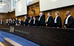 (From R) South African Judge Dire Tladi, US Judge Sarah Cleveland, Brazilian Judge Leonardo Nemer Caldeira Brant, German Judge Georg Nolte, Idian Judge Dalveer Bhandari, Somali Judge Abdulqawi Yusuf, Slovak Judge Peter Tomka, Lebanese Judge and President of the International Court of Justice (ICJ) Nawaf Salam, Ugandan Judge and 
Vice-President of the International Court of Justice Julia Sebutinde, French Judge Ronny Abraham, Chinese Judge Xue Hanqin, Japanese Judge Yuji Iwasawa, Australian Judge Hilary Charlesworth, Mexican Judge Juan Manuel Gomez Robledo, Romanian Judge Bogdan Lucian Aurescu rise before delivering a non-binding ruling on the legal consequences of the Israeli occupation of the West Bank and East Jerusalem at the International Court of Justice (ICJ) in The Hague on July 19, 2024.. The UN's top court handed down its view, on July 19, 2024, declaring "illegal" Israel's occupation of Palestinian territories since 1967, amid growing international pressure over the war in Gaza. (Photo by Nick...