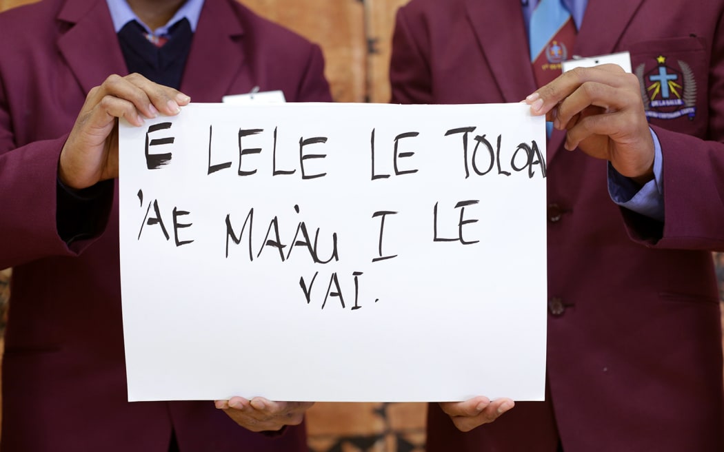 The De La Salle College debating team. "E lele le toloa 'ae ma'au i le vai."