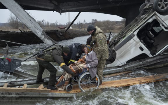 A woman on wheelchair leaves the city of Irpin during the evacuation during the Russia-Ukraine War, on March 7, 2022 (