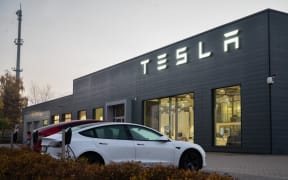 12 November 2021, Lower Saxony, Hanover: Cars park past a dealership of electric car maker Tesla. Tesla's stock has gained about 50 percent since the beginning of the year.