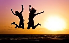 women jumping joyfully
