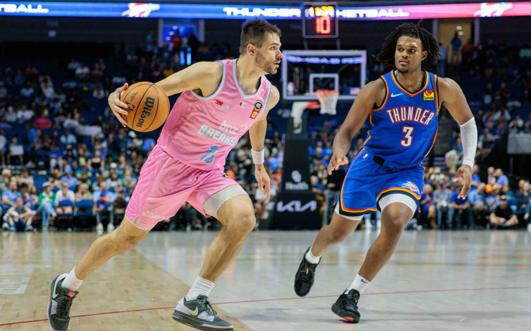 Matt Mooney #13 of the New Zealand Breakers drives past Dillon Jones #3 of the Oklahoma City Thunder