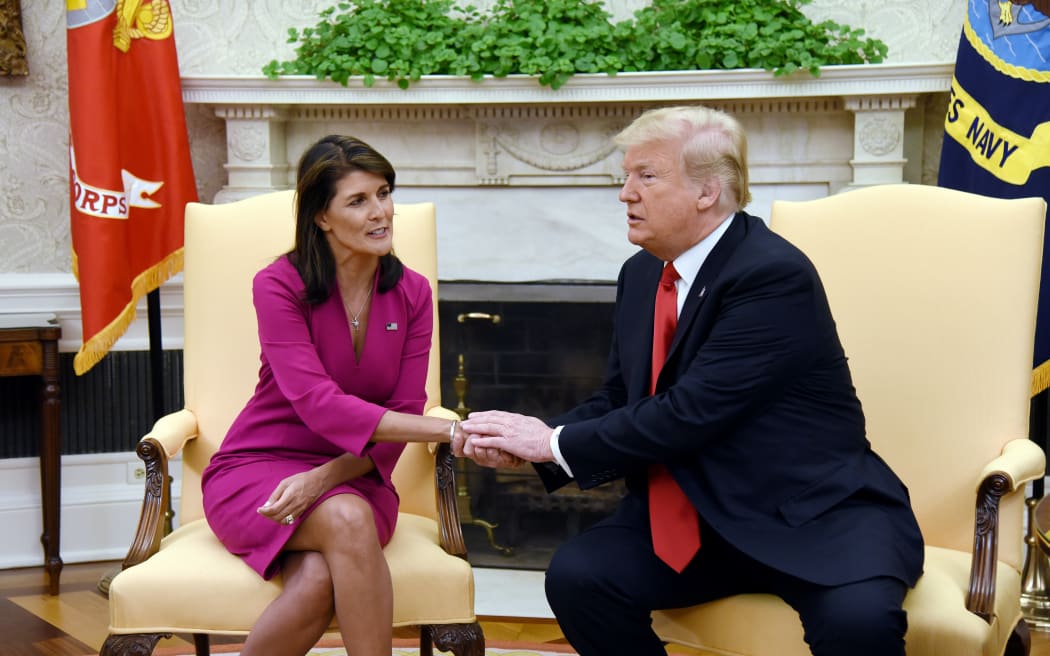 US President Donald Trump shakes hands with Nikki Haley, the United States Ambassador to the United Nations in the Oval office.