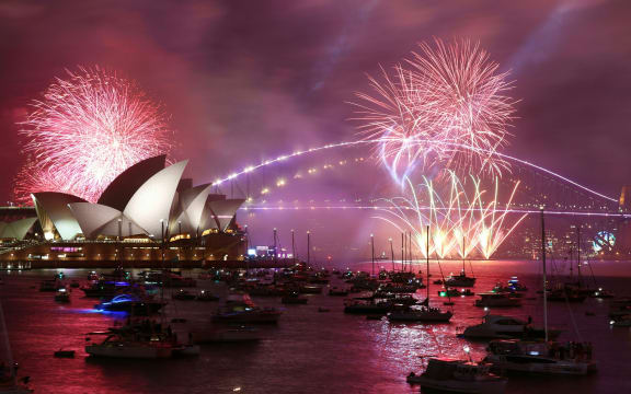 Sydney's 'family fireworks', displayed three hours before midnight every year ahead of the main show at midnight, fill the sky over the Opera House in Sydney on New Year's Eve on 31 December, 2022.