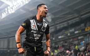 Ronaldo Mulitalo of New Zealand celebrates scoring his sides first try against Fiji in their quarter final clash at the Rugby League World Cup.