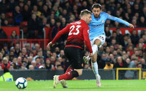 Manchester City's Bernardo Silva scores against Manchester United at Old Trafford.