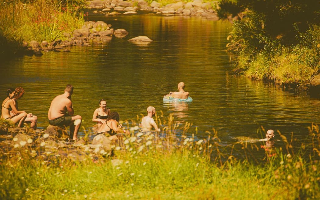 River Sounds Festival concertgoers cool off in a nearby river