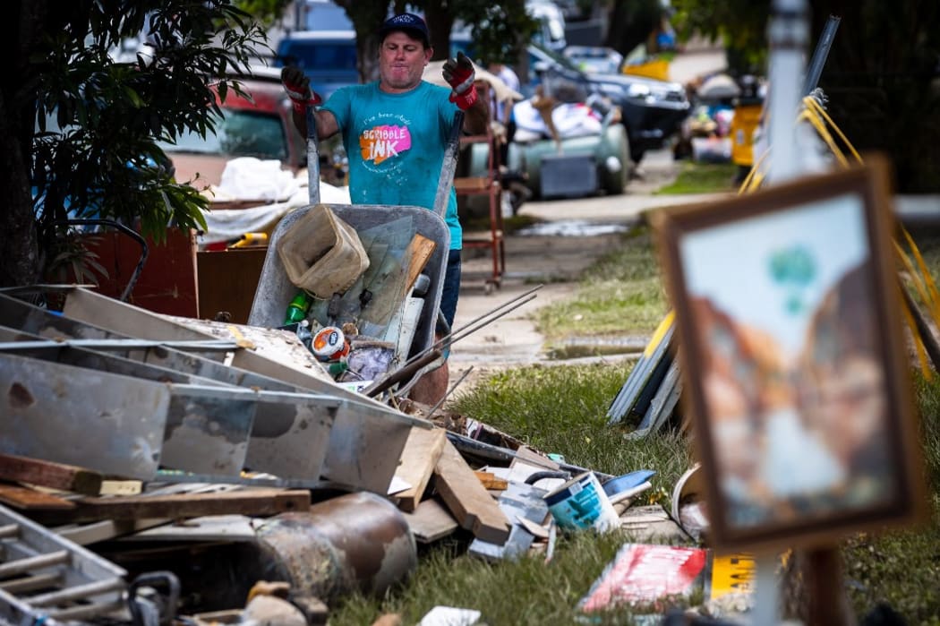 A resident discards items in the flood-damaged suburb of Newmarket in Brisbane on March 1, 2022.