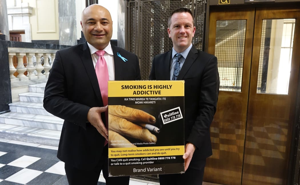 Associate Health Minister Sam Lotu-Iiga, left, and health select committee chairman Simon O’Connor with an example of the plain packaging.