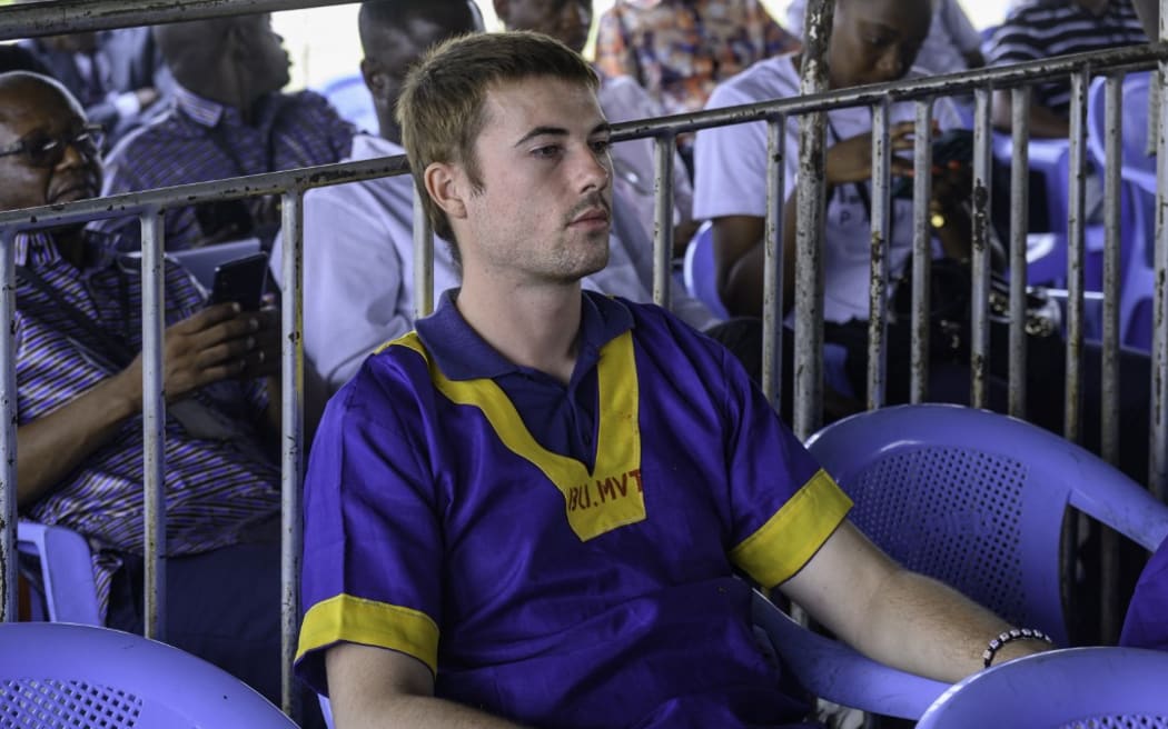 US national Taylor Thomson (C) sits among others accused of a failed coup attempt while attending trial at Ndolo prison in Kinshasa on September 13, 2024. Three Americans were among 37 people sentenced to death on September 13, 2024 in the Democratic Republic of Congo over what the army says was a coup attempt.
Death sentences were also handed down to a Belgian, Briton and Canadian, all naturalised Congolese. (Photo by Hardy BOPE / AFP)