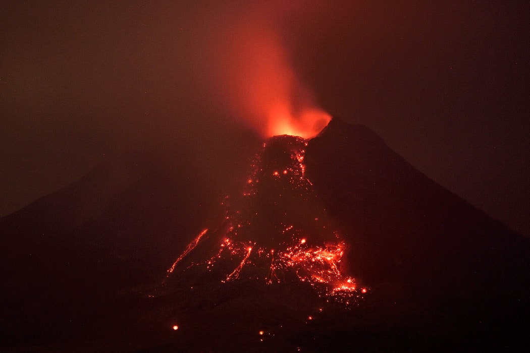 Molten lava flows from the crater of Mount Sinaberg on 27 January during a series of eruptions.