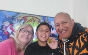 Charlie Ross-Matenga, 11, (centre) with mum, Sue Kara, and dad Patrick Kara.
