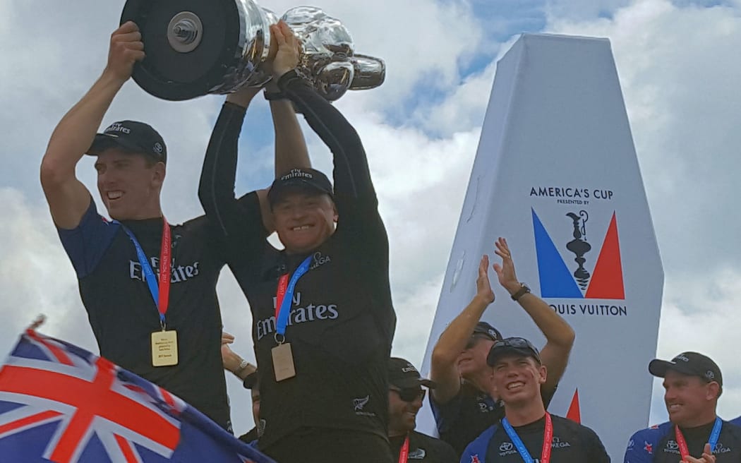 Burling and Ashby raise cup during parade