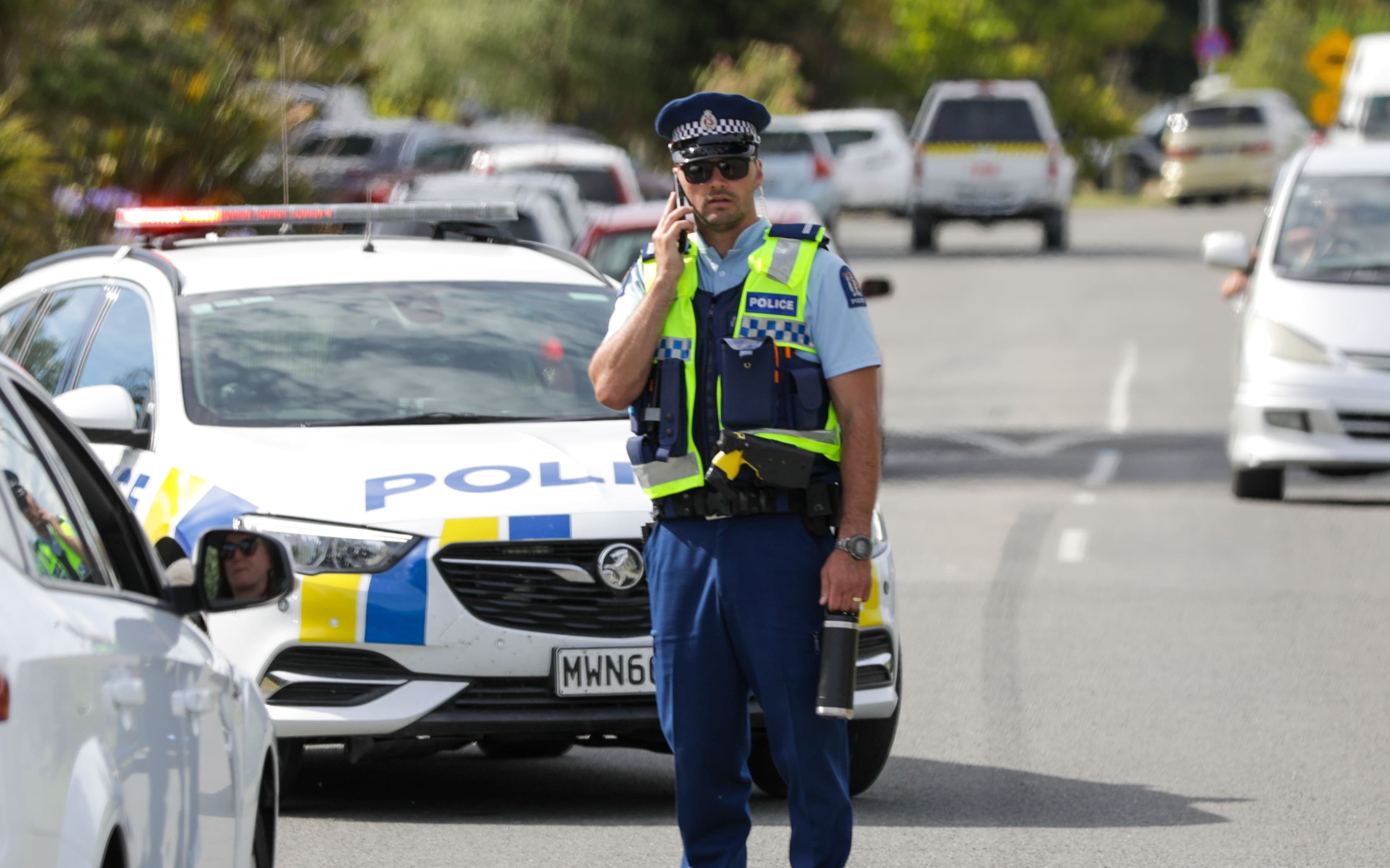 Police manage traffic as emergency services respond to a fire threatening homes near Pines Beach on 25 January.