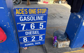 The gas and diesel price sign at Ace's One Stop fuel station in Majuro shows the latest fuel prices in US dollars drivers are paying at the pump three weeks into the US-Israel war on Iran.