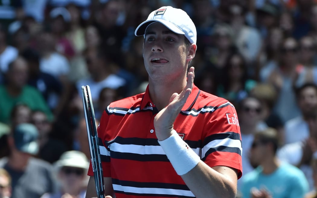 John Isner celebrates his win against Feliciano Lopez on day six of the 2016 Australian Open, January 23, 2016. AFP PHOTO / SAEED KHAN
