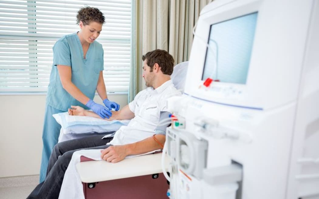 Nurse preparing dialysis patient (stock photo)