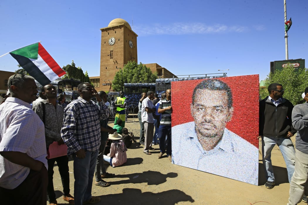 Sudanese protesters rally in front of a court in Omdurman near the capital Khartoum, on December 30, 2019, during the trial of intelligence agents for the death of teacher Ahmed Al-Khair (picture) while in custody of intelligence services.