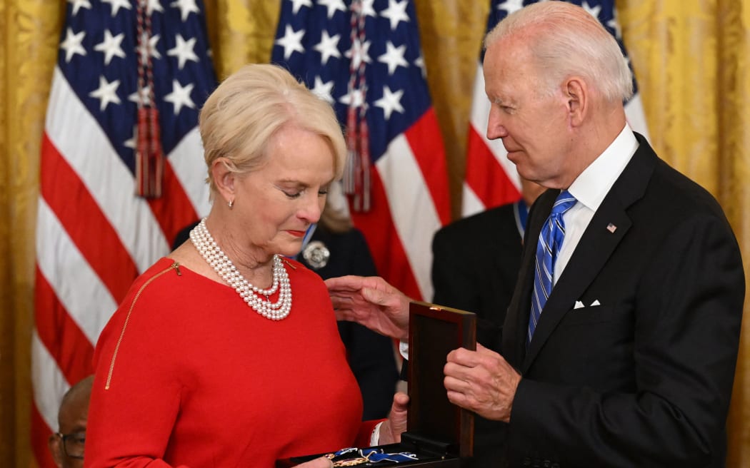 US President Joe Biden presents Cindy McCain (L), the widdow of former Senator and presidential candidate John McCain, posthumously with the Presidential Medal of Freedom, the nation's highest civilian honor, during a ceremony honoring 17 recipients, in the East Room of the White House in Washington, DC, July 7, 2022. (Photo by SAUL LOEB / AFP)