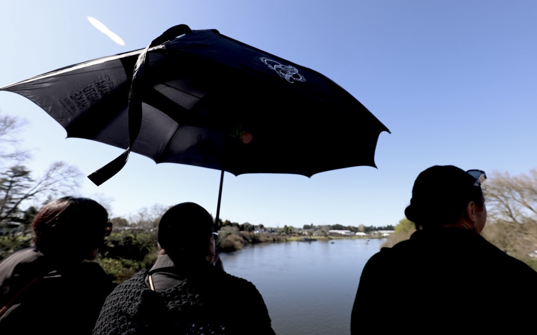 Crowds outside Turangawaewae Marae wait for Kiingi Tuheitia's body to be transported up the Waikato river to his final resting place at Taupiri maunga