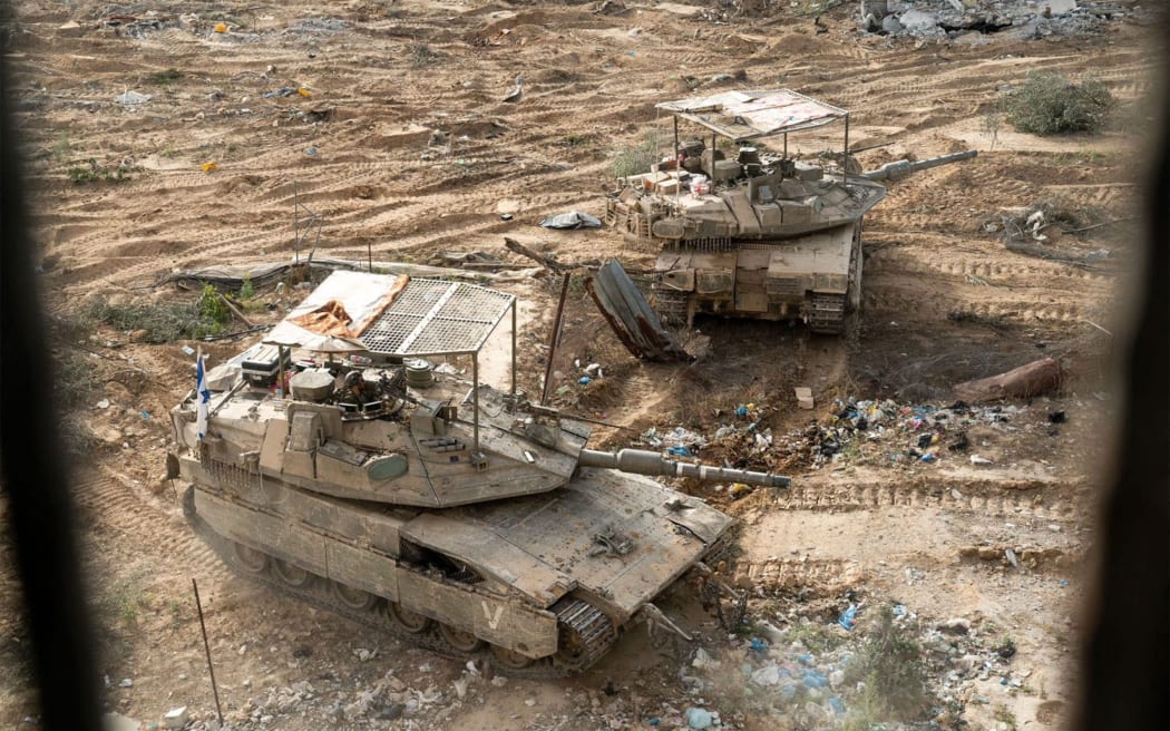 This handout picture released by the Israeli army on June 23, 2024 reportedly shows Israeli army main battle tanks operating in Rafah in the southern the Gaza Strip amid the ongoing conflict in the Palestinian territory between Israel and Hamas. (Photo by Israeli Army / AFP) / === RESTRICTED TO EDITORIAL USE - MANDATORY CREDIT "AFP PHOTO / Handout / Israeli Army' - NO MARKETING NO ADVERTISING CAMPAIGNS - DISTRIBUTED AS A SERVICE TO CLIENTS ==
