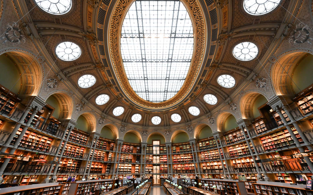 (FILES) This picture taken in Paris on February 13, 2024 shows a general view of the "Salle Ovale Richelieu" of the Richelieu-Louvois Library (Bibliotheque Nationale de France - National Library of France - BnF). France's national library said on April 25, 2024, that it had removed four 19th-century books from its shelves whose emerald green covers were likely laced with highly poisonous arsenic. The library said handling the books, which were printed in Britain, would probably cause only minor harm, but it was putting them away into quarantine for further analysis. (Photo by Stefano RELLANDINI / AFP)