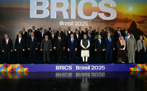 Heads of state and government of member, partner, and external engagement countries pose for a family photo during the BRICS summit in Rio de Janeiro, Brazil, on July 7, 2025. BRICS leaders at a summit on Sunday took aim at US President Donald Trump's "indiscriminate" import tariffs and recent Israeli-US strikes on Iran. (Photo by Pablo PORCIUNCULA / AFP)
