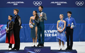 Madison Chock and Evan Bates (USA) win the silver medal, Laurence Fournier Beaudry and Guillaume Cizeron (FRA) win the gold medal and Pipper Gilles and Paul Poirier (CAN) win the bronze medal in Figure Skating, Ice dance, Free Dance, during the Olympic Winter Games Milano Cortina 2026, at Milano Ice Skating Arena, in Milan, Italy, on February 11, 2026, Photo Philippe Millereau / KMSP (Photo by MILLEREAU Philippe / KMSP via AFP)
